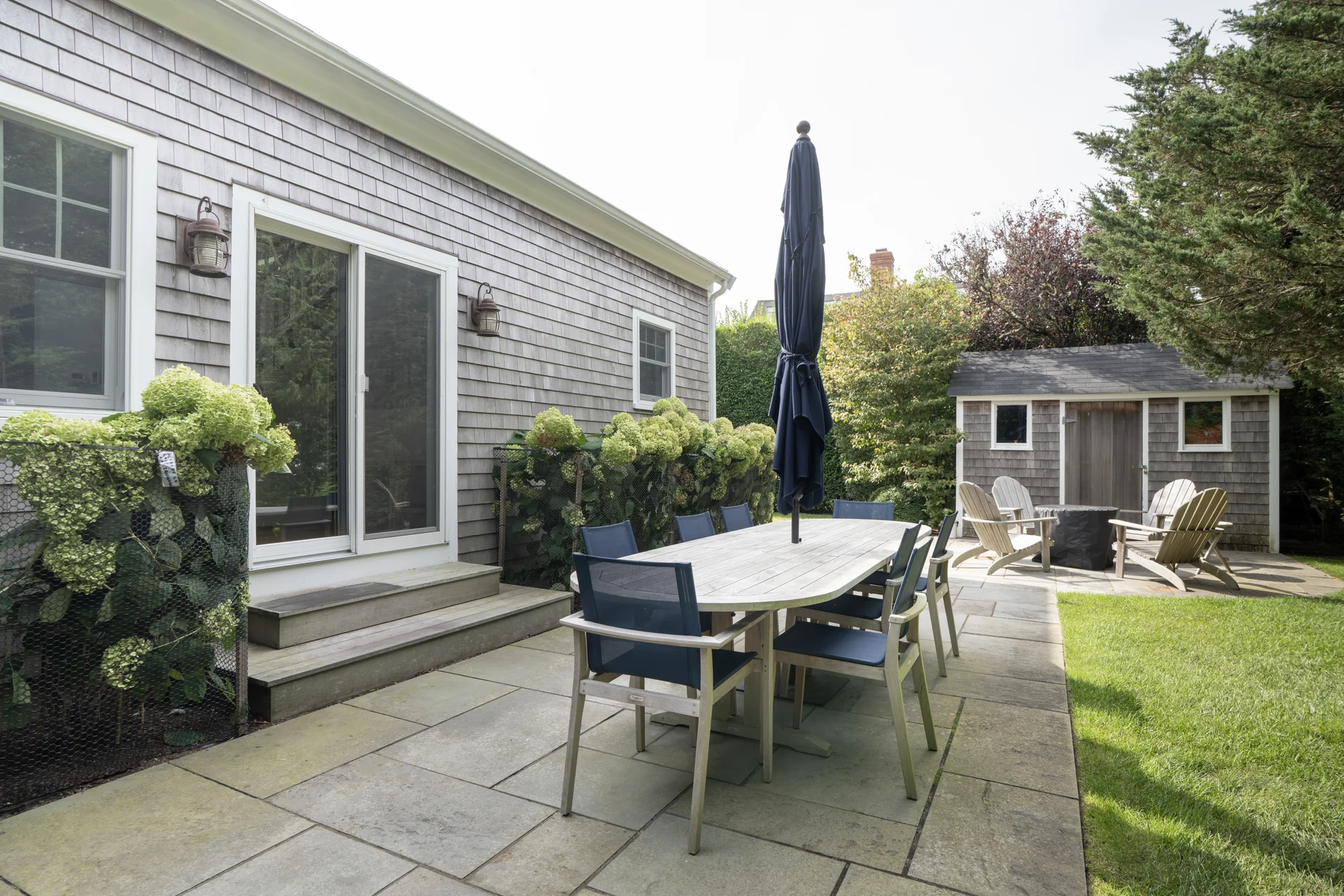 Backyard patio dining area in Nantucket home renovation