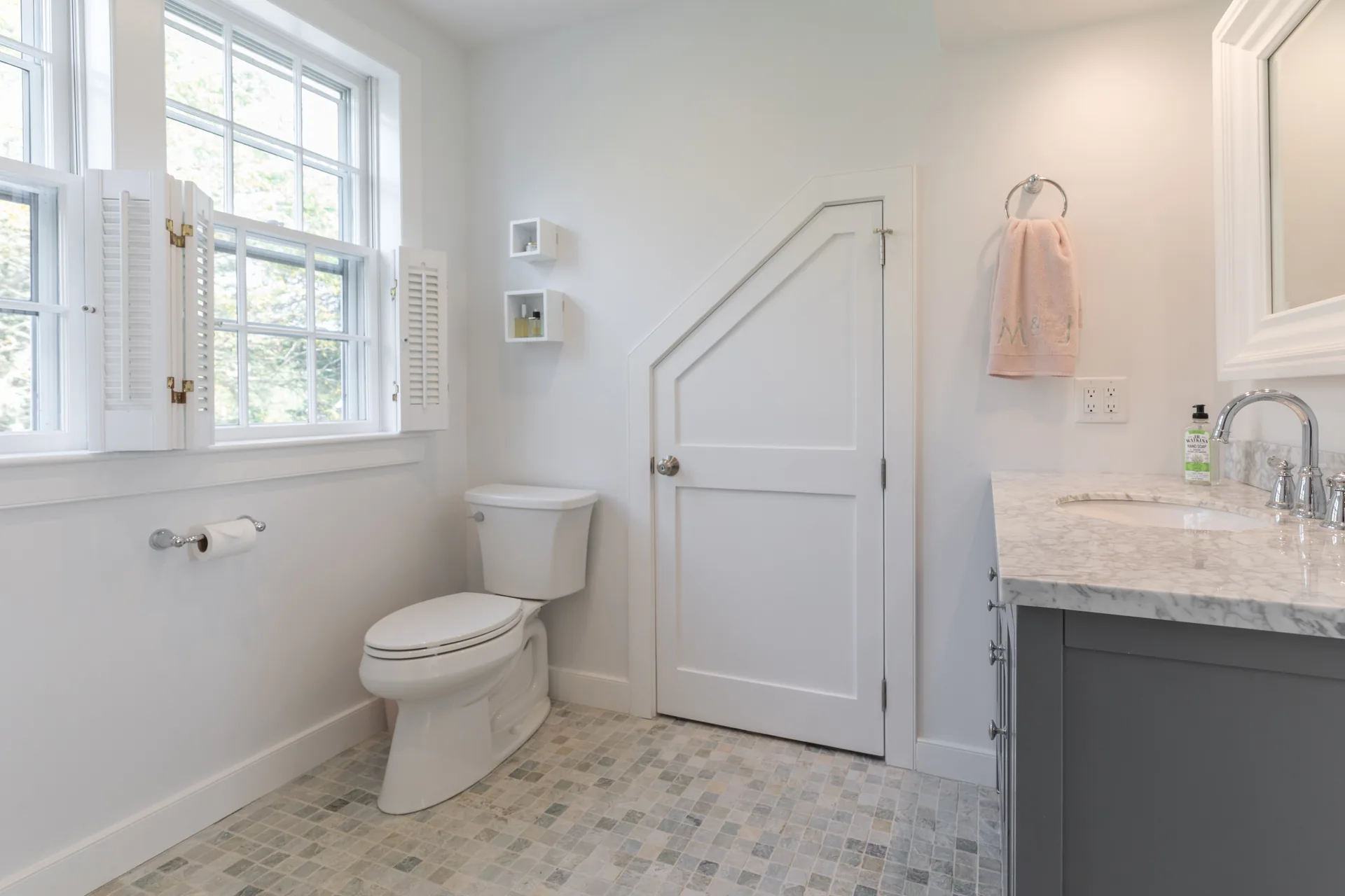 Bathroom with marble countertop and mosaic tile floor