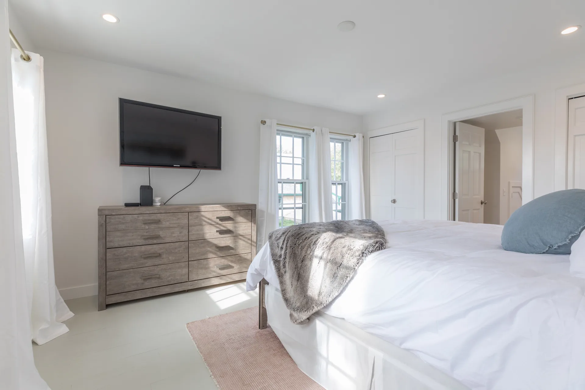Master bedroom TV wall with rustic dresser