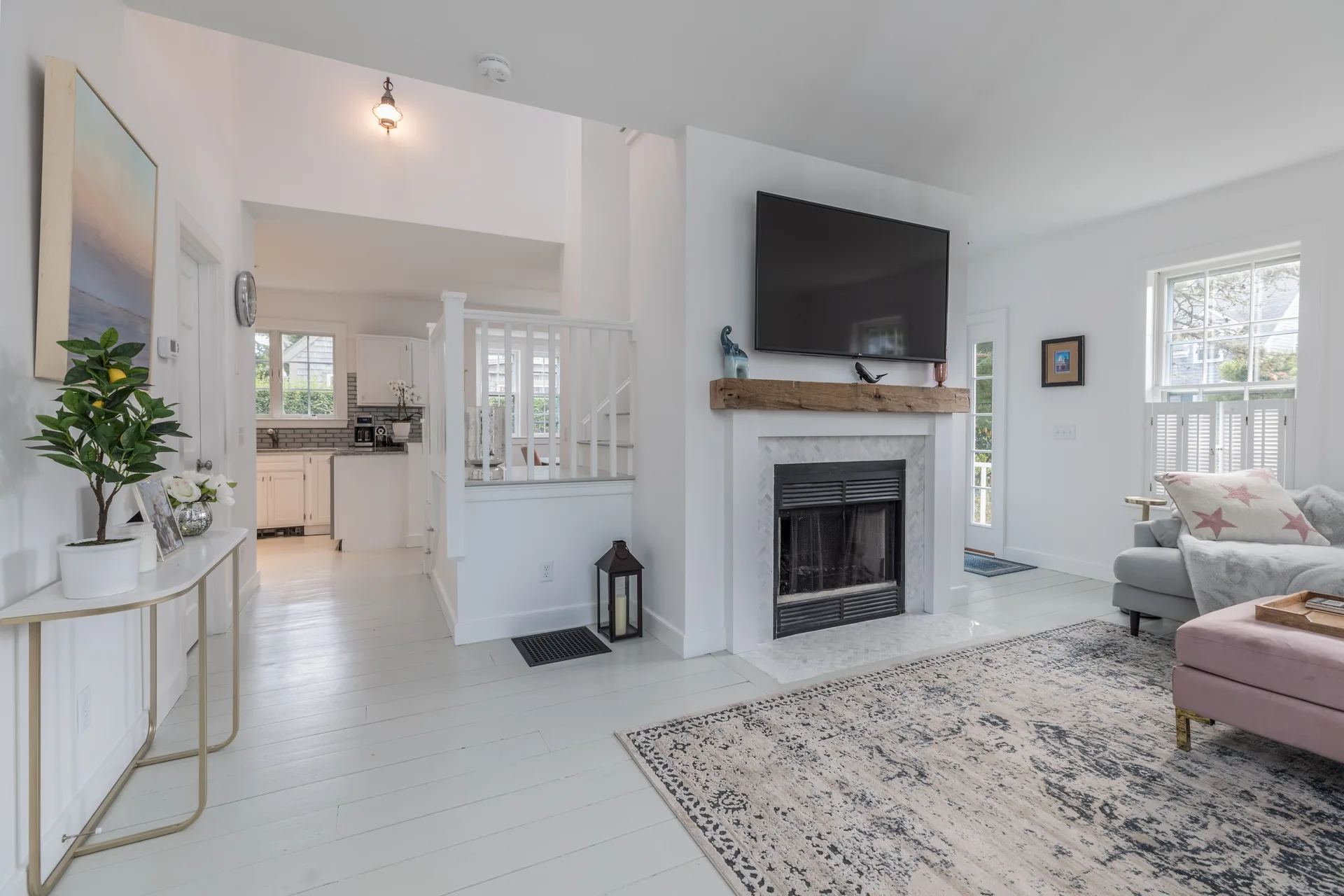 Open plan living and kitchen area with fireplace wall