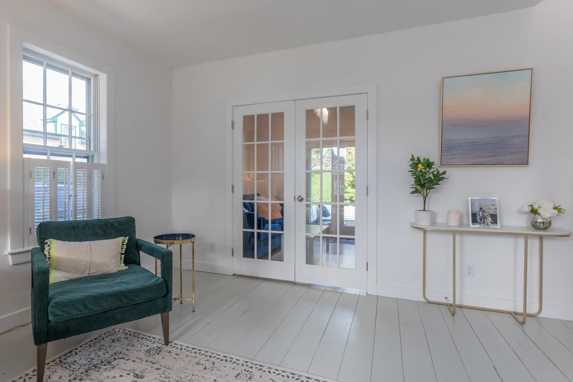 Sitting room with green armchair and French doors