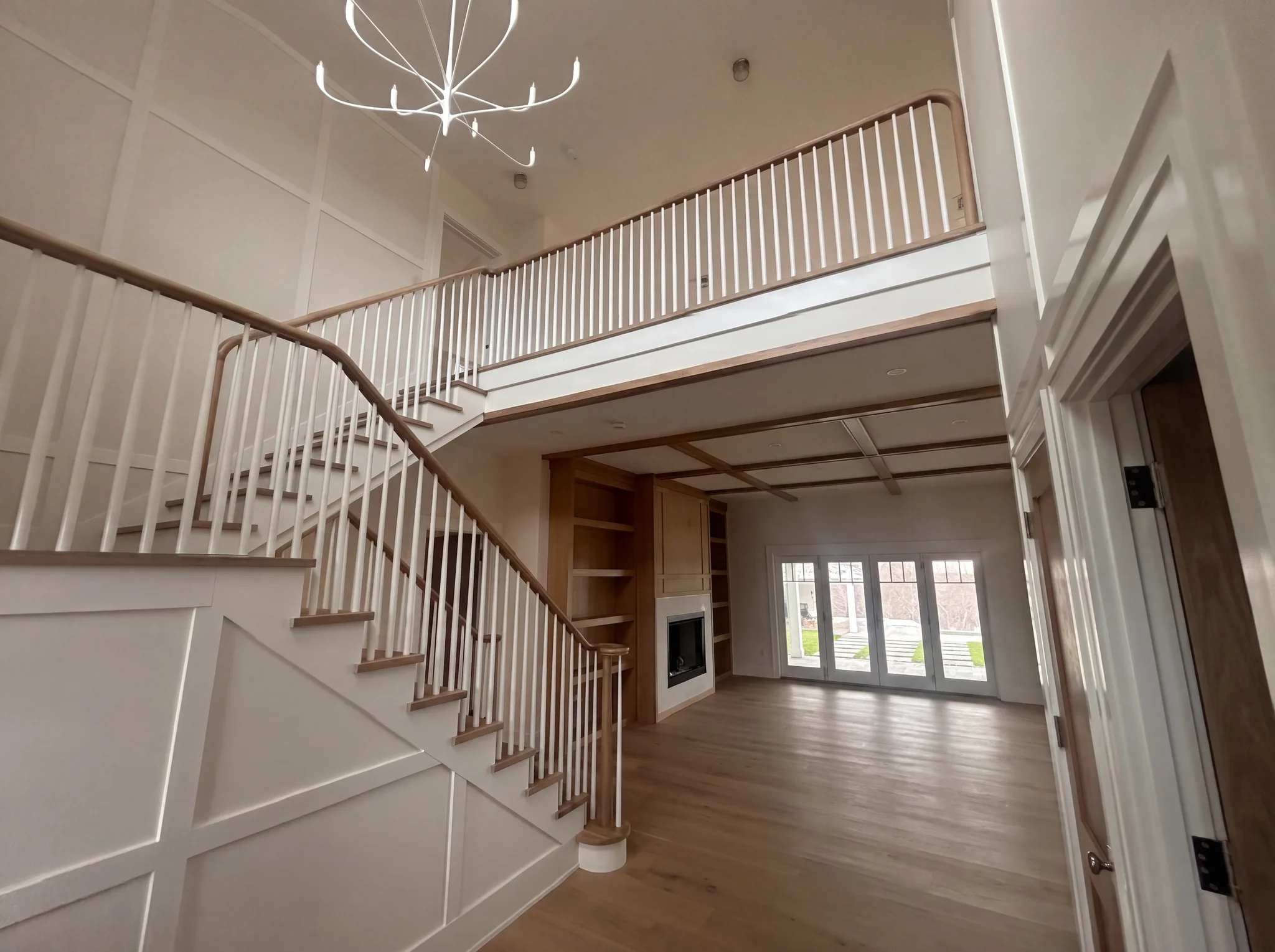 Entry with custom staircase and living room at the North Pasture Lane Project