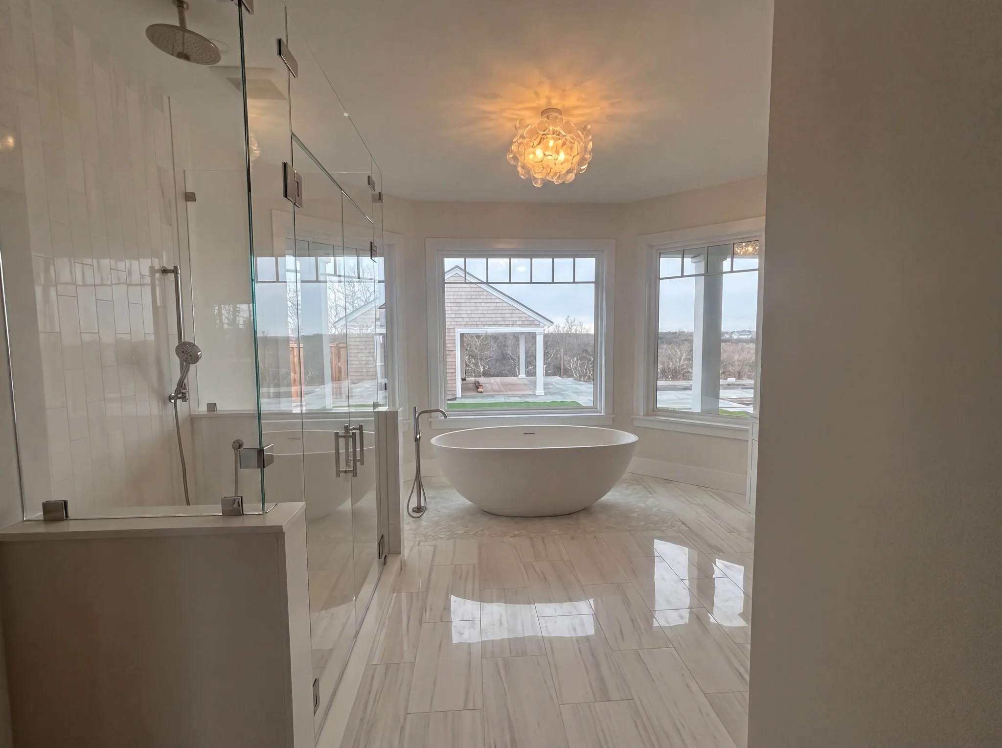 Primary bathroom with freestanding tub and glass shower at North Pasture Lane